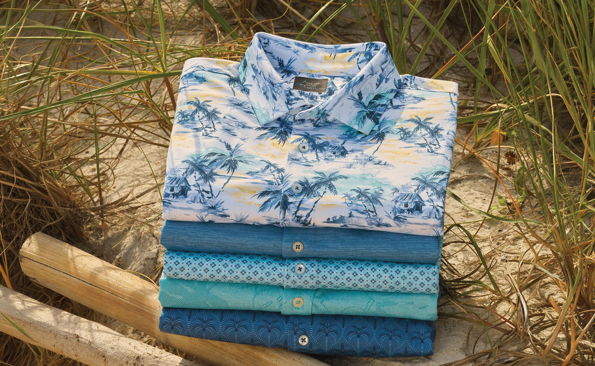 Folded Greg Norman Collection golf polos in different colors
