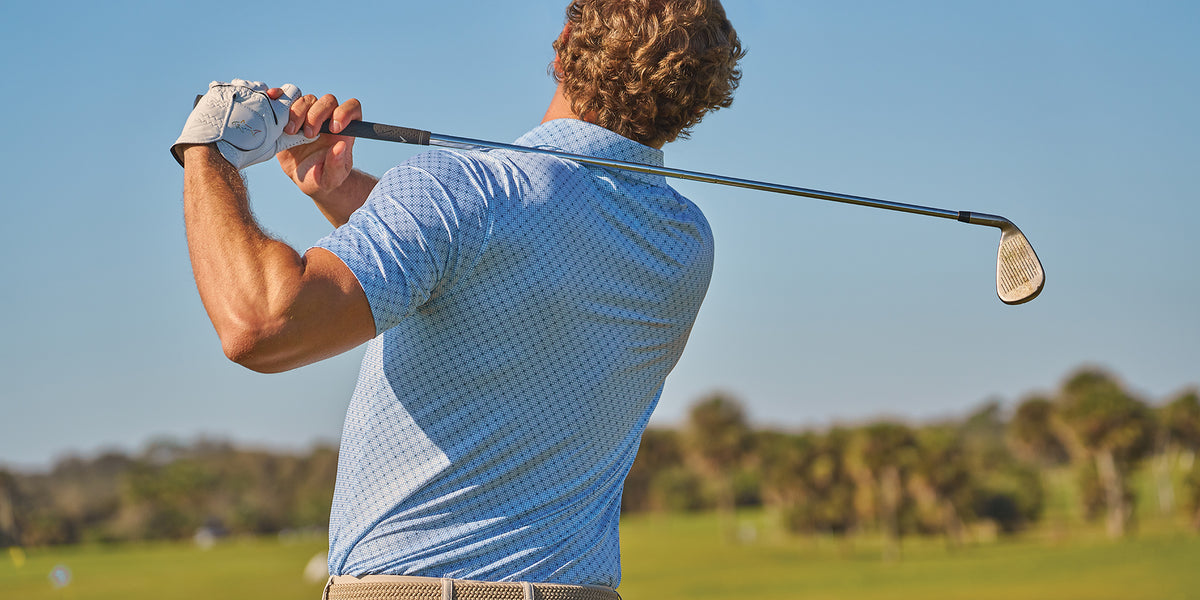 Golfer wearing Greg Norman Collection apparel on a golf course