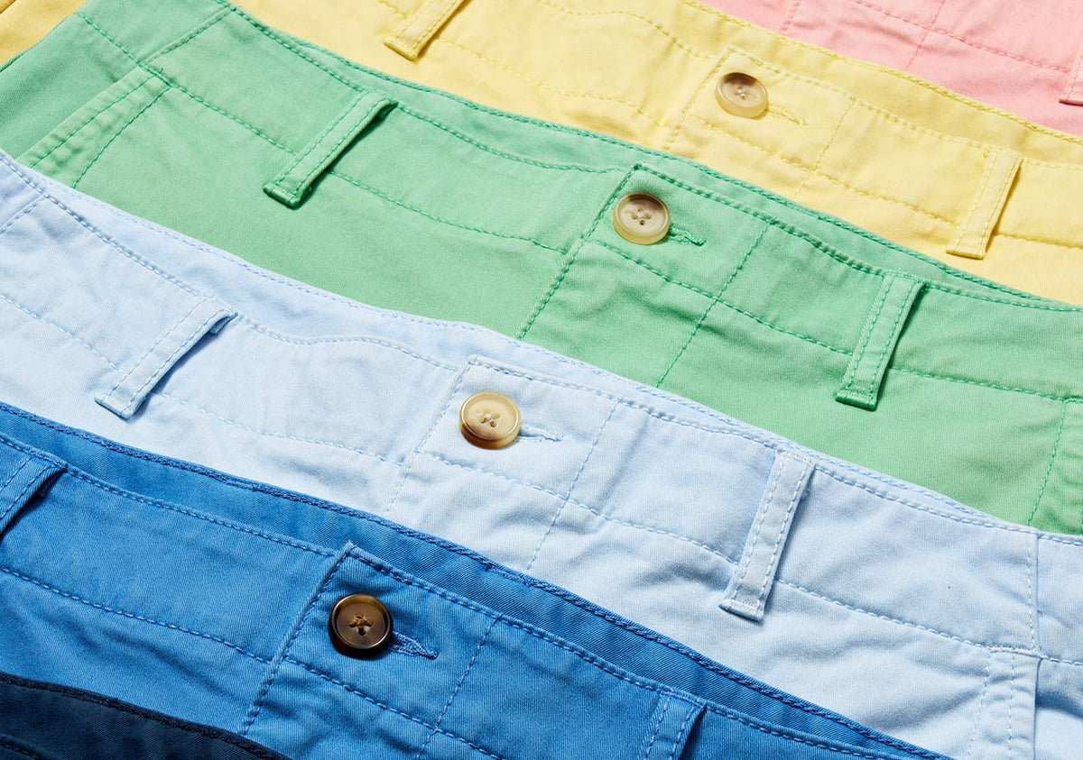 Close-up detail of Greg Norman Collection golf shorts in several colors